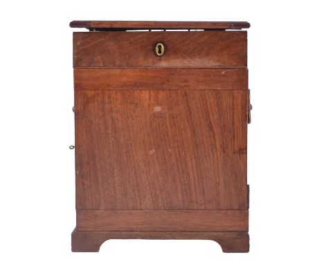 George III mahogany apothecary chest, hinged lid enclosing compartments and later glass bottles, two hinged doors enclosing f