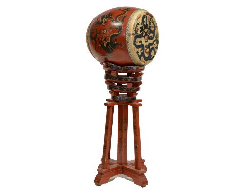 Chinese red lacquered and painted drum on a stand, the drum decorated with dragons, the sectional top of the stand painted wi