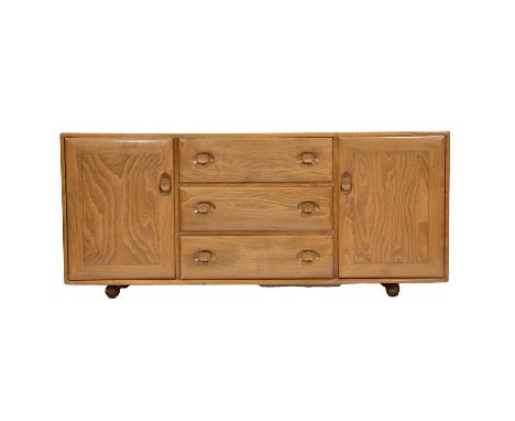 Ercol sideboard, elm and beech, fitted with three long drawers flanked by cupboards, on rollerball casters, width 156cm, dept