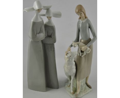 A Lladro glazed ceramic group, shepherdess tending her flock, together with another similar, two holy sisters (2)