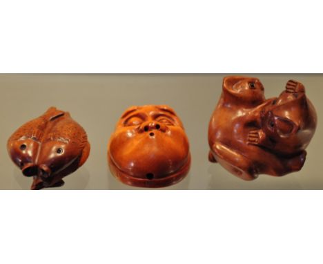 Three hardwood netsuke in the forms of two kittens, fish and a mans face