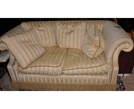 A two-seater sofa by Parker & Farr, with scroll arms and feather-filled loose cushions, upholstered in ivory striped chenile 