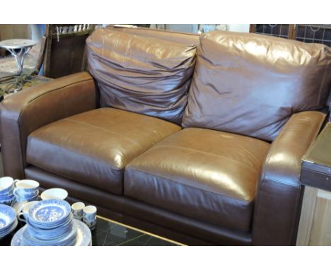 A contemporary brown leather two seater sofa with feather-filled seat and cushions