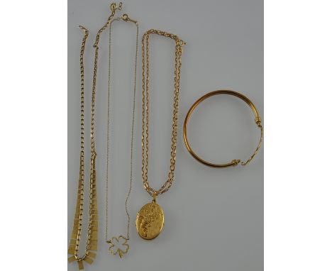 A collection of 9ct yellow gold jewellery comprising an oval portrait locket, a hollow bangle, a fringe necklace and a shamro