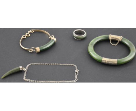 A hinged jade bangle with white metal mounts, together with a pendant, ring and a bracelet, (4).