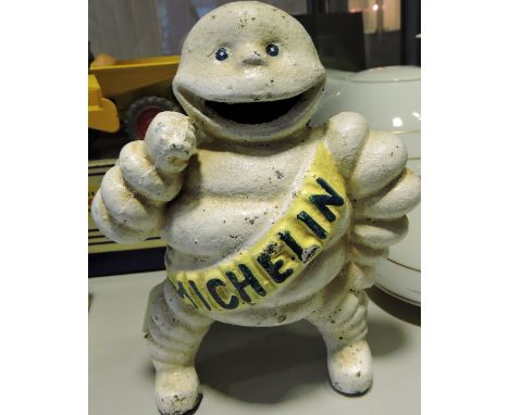 A cast iron Michelin Man with yellow sash, H 15cm