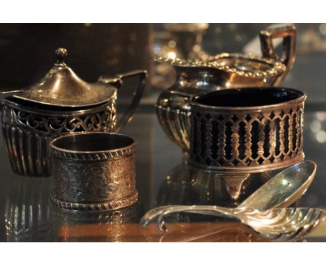 A Victorian silver caddy spoon with bright cut bowl, a white metal caddy spoon, an early Victorian silver cream jug, a silver