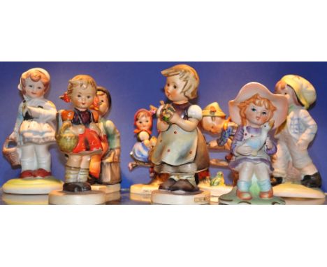 A collection of 8 Hummel figures