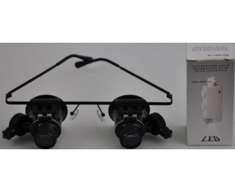 A set of jeweller's loupe spectacles with LED lights together with a microscope with LED light