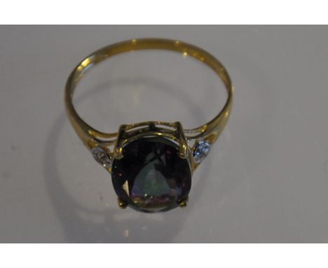 A topaz and diamond ring, claw set in a 9ct yellow gold band