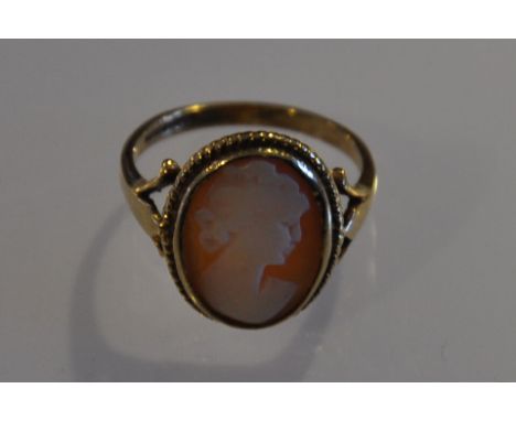 An early 20th Century carved cameo portrait ring within a 9ct gold rope twist frame and band