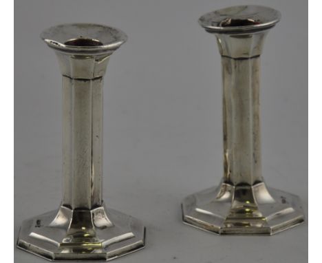 A pair of octagonal silver candlesticks hallmarked Sheffield 1913 by Walker and Hall