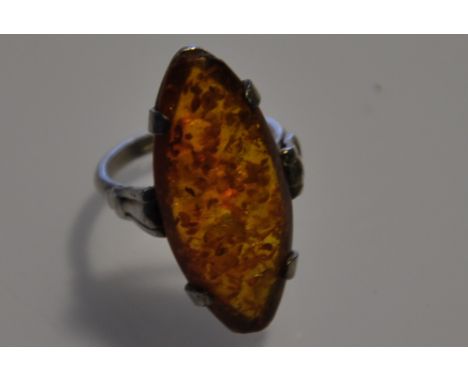 A stamped white metal ring with amber stone
