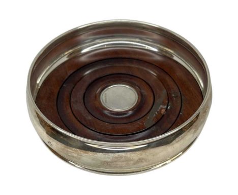 Silver Bottle Coaster. Sheffield 2000, Carr's of Sheffield Ltd.With turned wooden base.Diameter 12.5 cmsCondition report: Goo