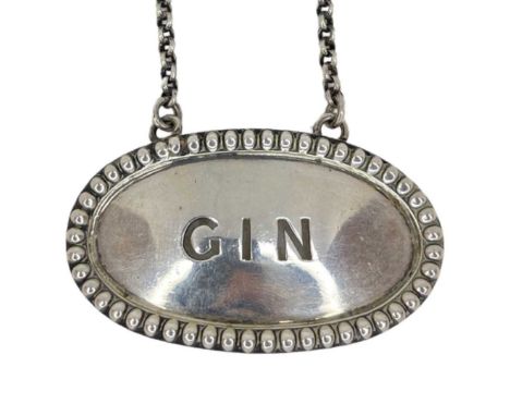 Silver 'Gin' Label. 25 g. London 1863, Thomas Henry Francis &amp; Frederick Francis. Beaded rim decoration.Width 5.5 cms. Con