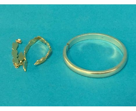 An 18ct Bi-coloured bracelet and a silver bangle