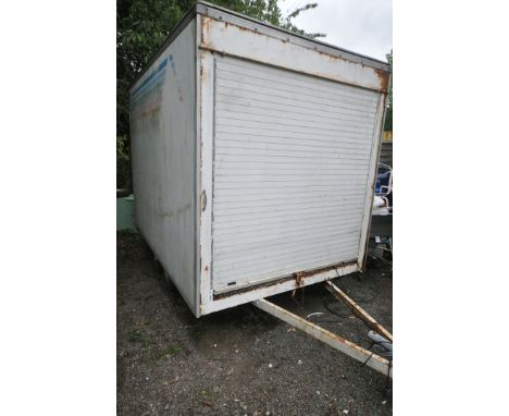A LARGE TWIN AXLE BOX VAN TRAILER, with a roller at each end, length 306cm x 202cm wide x height 255cm (condition report:-rol