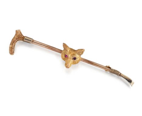A FOX MASK BAR BROOCH, the naturalistically modelled fox head, set with red hardstone eyes, to hunting crop bar, pin with hin