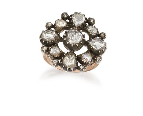 A DIAMOND CLUSTER RING, the central rose cut diamond, claw mounted with a closed back, surrounded in an open frame of smaller