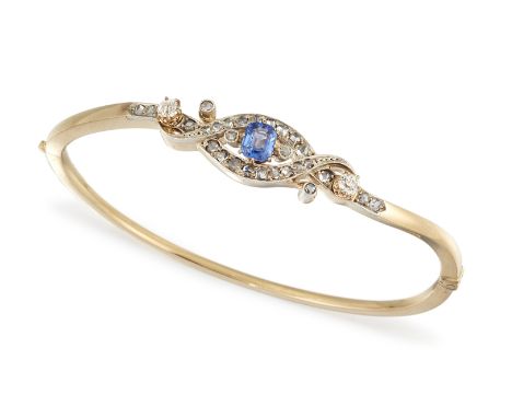 A SAPPHIRE AND DIAMOND BANGLE, the octagonal sapphire, estimated approx. 0.30cts, claw mounted to the centre of two crossover