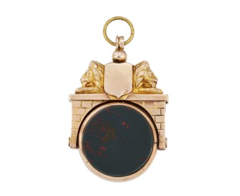 A DOUBLE SIDED HARDSTONE FOB, the round fob set with carnelian to one side and bloodstone to the other, rotating in a surroun