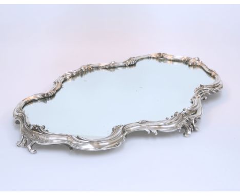 A FABERGE SILVER MIRROR PLATEAU, Moscow 1899-1908, of shaped oblong form with silver rim moulded with scrolls, rocaille and s