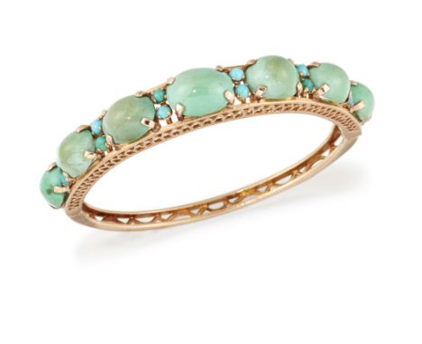 A 9CT GOLD TURQUOISE BANGLE, the upper half set with seven graduated turquoise cabochons, each claw set and interspaced with 