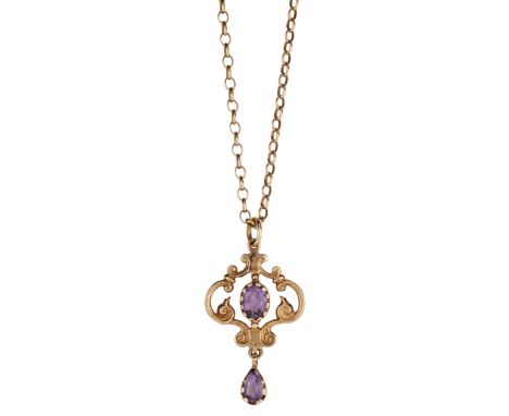 A 9CT AMETHYST PENDANT AND CHAIN, the Edwardian style pendant set with an amethyst to centre and with a pear-shaped amethyst 