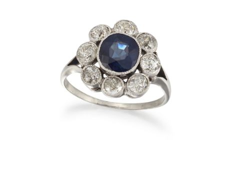 A SAPPHIRE AND DIAMOND CLUSTER RING, the off-round sapphire, estimated approx. 1.97cts, surrounded by eight old cut diamonds,