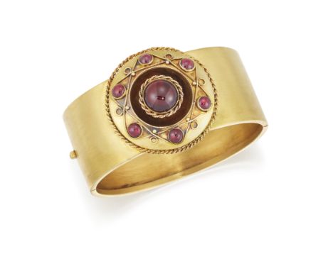 A 19TH CENTURY GARNET BANGLE, the 25mm wide hinged bangle, set to centre with a round garnet cabochon, collet mounted with ro