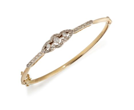 AN EARLY 20TH CENTURY DIAMOND BANGLE, set to centre with three graduated old cut diamonds, with an open scalloped navette fra