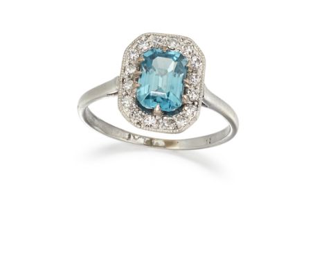 A ZIRCON AND DIAMOND RING, the blue octagonal zircon, claw mounted and surrounded by single cut diamonds in milligrain mounts