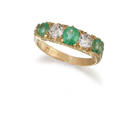 A LATE VICTORIAN 18CT EMERALD AND DIAMOND RING, the three cushion cut emeralds interspaced with old cut diamonds, total weigh