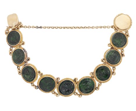 A CHINESE JADE BRACELET, the dark green roundels with carved Chinese characters, each collet mounted and separated by short l