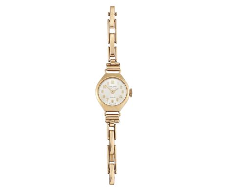 A LADY'S 9CT WRISTWATCH, the round satin finish dial signed Excalibur, with gilt Arabic numbers and hands, in gold case stamp