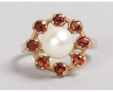 A GOLD, GARNET AND PEARL RING.