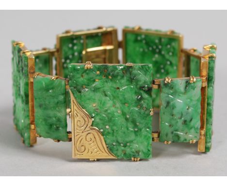 A SUPERB GOLD MOUNTED PIERCED AND CARVED GREEN JADE BRACELET, 19cms long, in original case David Seidler & Son, Boston.  Mono