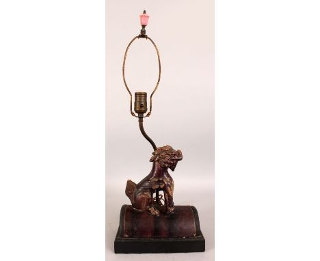 AN AUBERGINE GLAZED POTTERY ROOF TILE LAMP, possibly Ming Dynasty, modelled in the form of a seated Buddhistic lion, mounted 