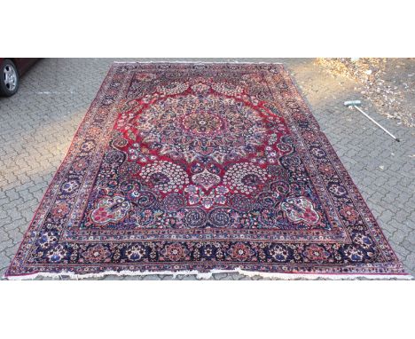 A GOOD LARGE MESHED CARPET, claret ground with all-over stylised floral decoration, signed. 18ft 3ins x 11ft 7ins.