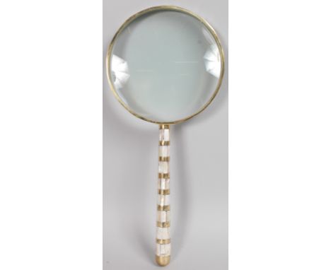 A LARGE MAGNIFYING GLASS with mother-of-pearl handle.