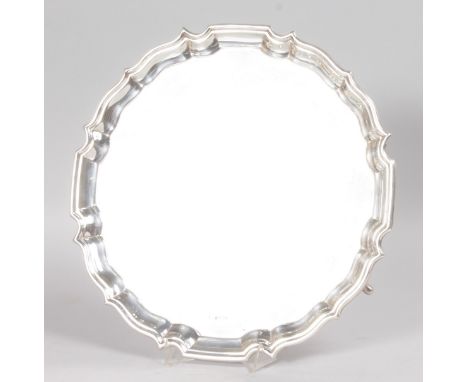 A GOOD PLAIN PIE CRUST SALVER, on three knurled feet, 12ins diameter. Sheffield 1937.  Maker: K. & D.  Weight 27ozs.  Retaile