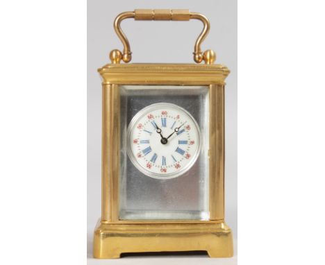 A MINIATURE BRASS CARRIAGE CLOCK with silvered face.  2.25ins high.
