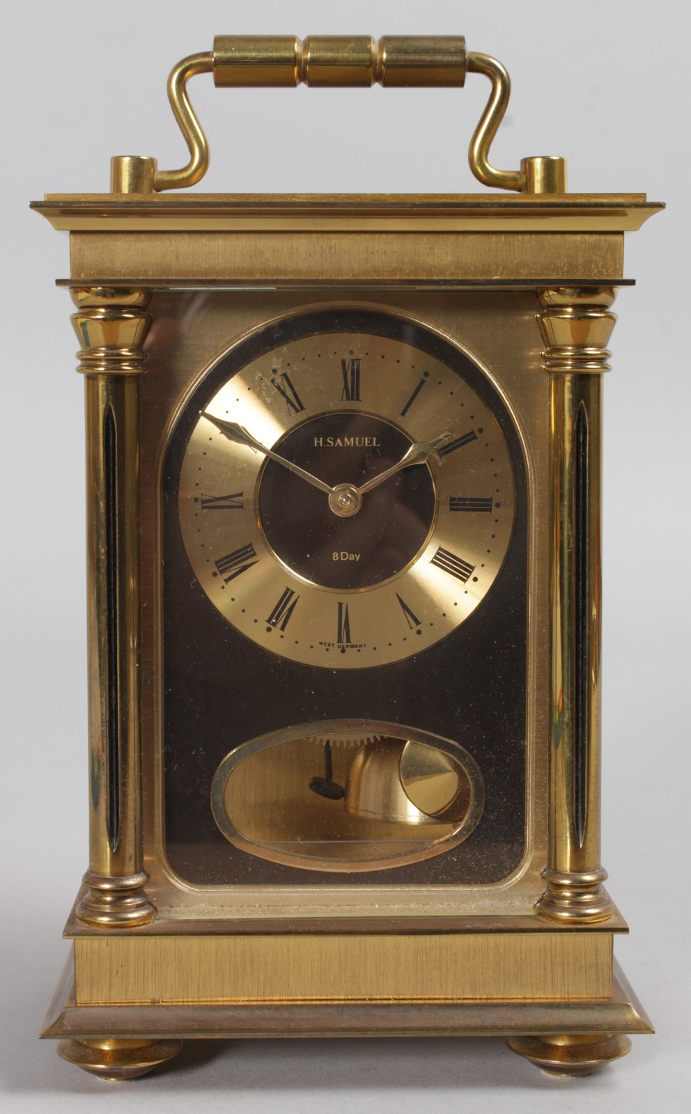H. SAMUEL. A BRASS CARRIAGE CLOCK. 7.5ins high.