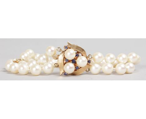 A 15CT GOLD DOUBLE ROW PEARL BRACELET.