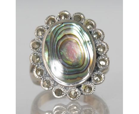 A MOTHER-OF-PEARL AND MARCASITE DRESS RING.