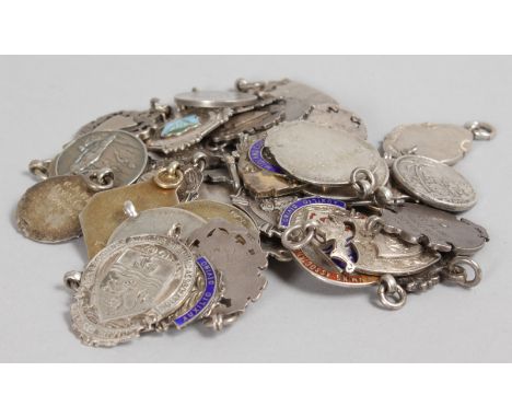 A GOOD COLLECTION OF SILVER AND ENAMEL SPORTING MEDALS.
