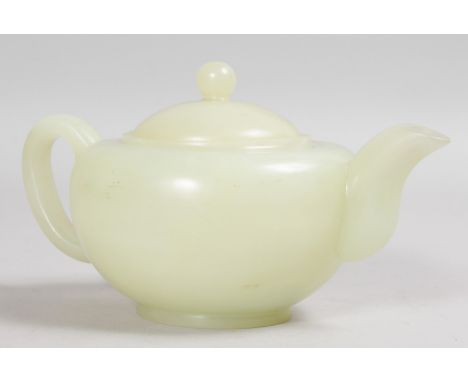 A PLAIN CHINESE JADE CIRCULAR TEAPOT AND COVER. 4.5ins diameter, 4.5ins high.