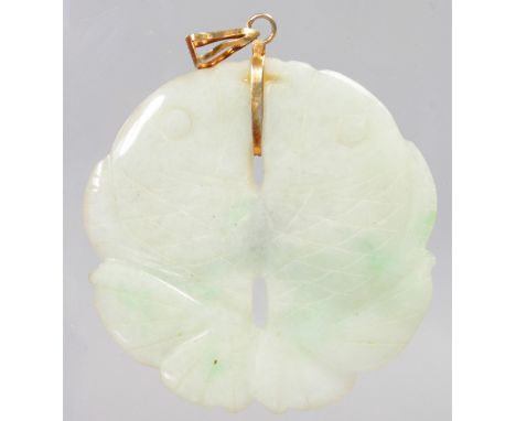 A CHINESE CARVED WHITE JADE PENDANT as two fish side by side. 5cms diameter.