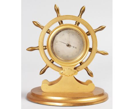 A GOOD "SHIPS WHEEL" BRASS BAROMETER by MANSFIELD, DUBLIN, on an oval base. 7.5ins high, 6.5ins diameter.