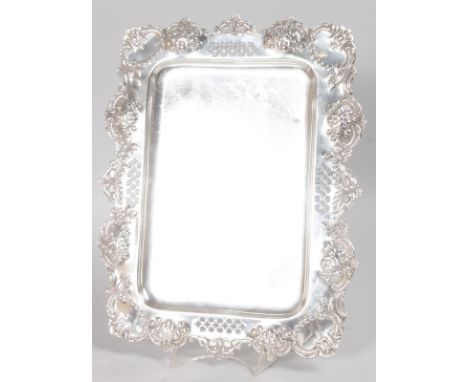 A VICTORIAN RECTANGULAR TRINKET TRAY with repousse and pierced edges. 13ins long.  Birmingham 1897.  Maker: H. & L. Weight 20